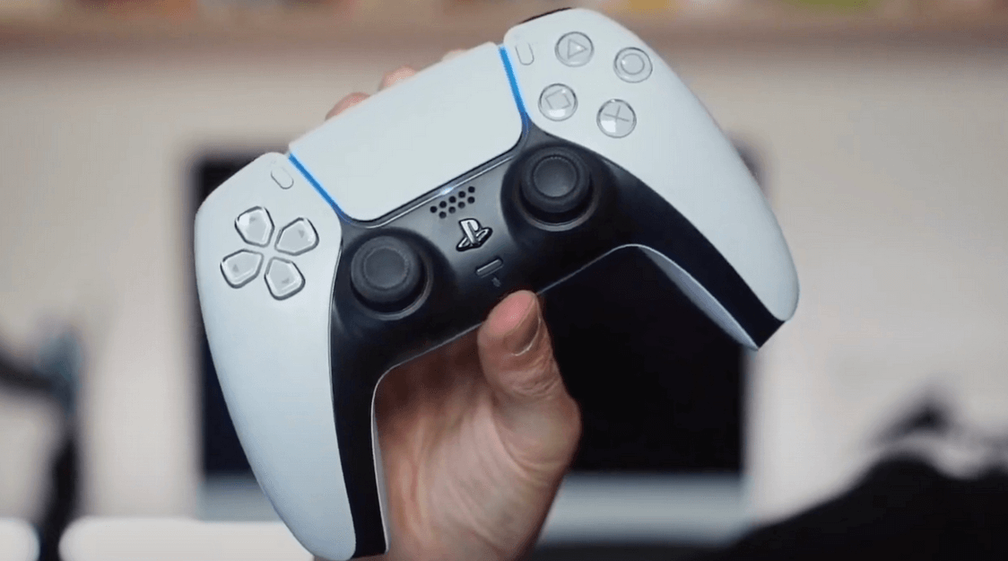 PS5 controller held up with one hand