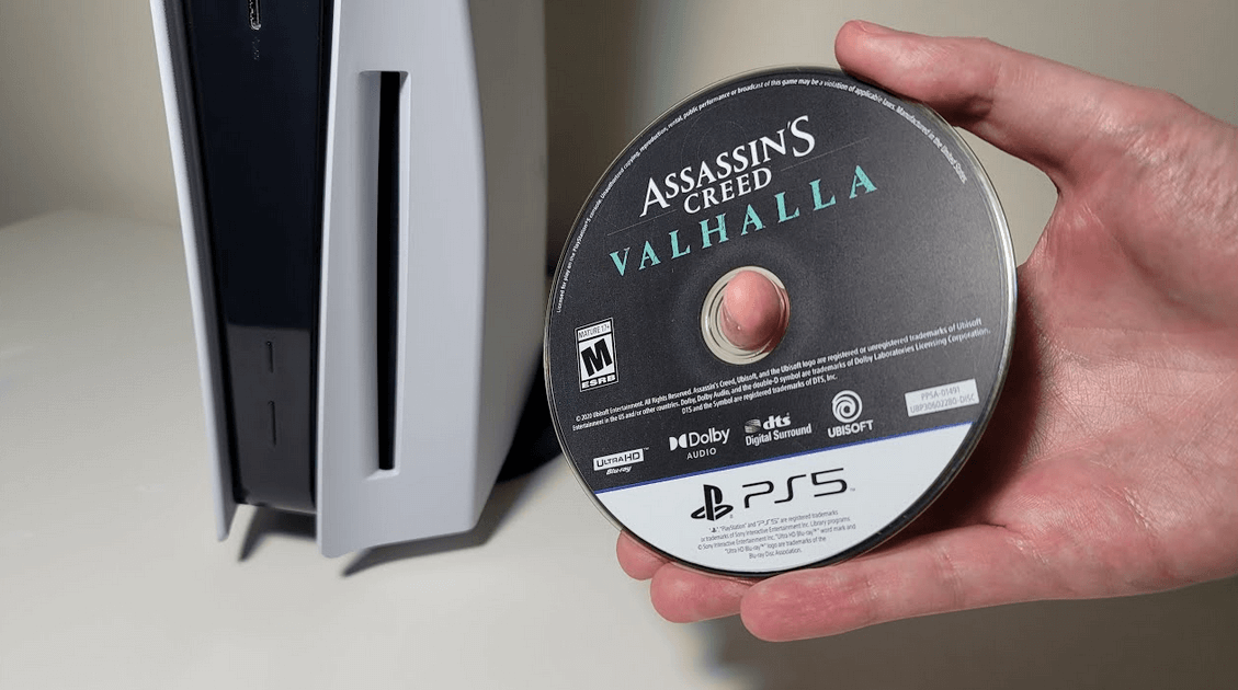 Hold a PS5 game disc next to a PS5 console